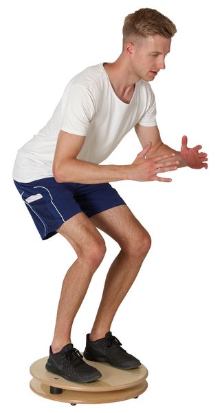 balancing board, balance board, cushioned platform, athletic shorts, white t-shirt