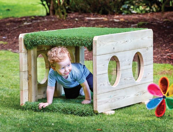 wooden playhouse, kid toy, grass roof, circular cutouts, outdoor play