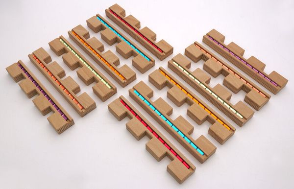 graphite, puzzle, wooden blocks, colorful rods, installation set