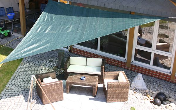 outdoor seating, patio set, woven furniture, cushioned chairs, coffee table