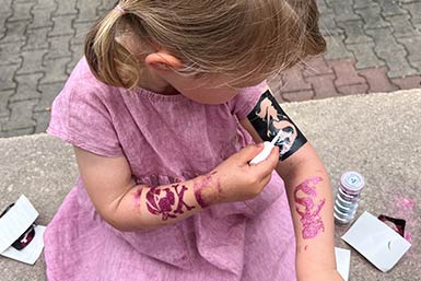 Mädchen mit Kindertattoos auf den Armen